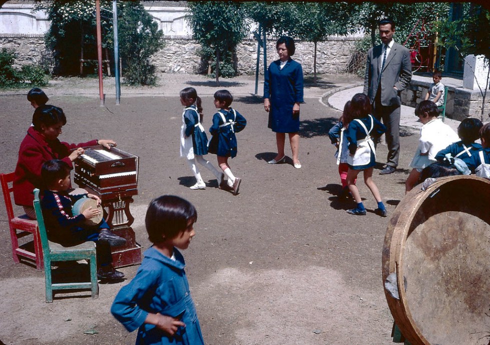 "Young students dancing to music on a school playground."