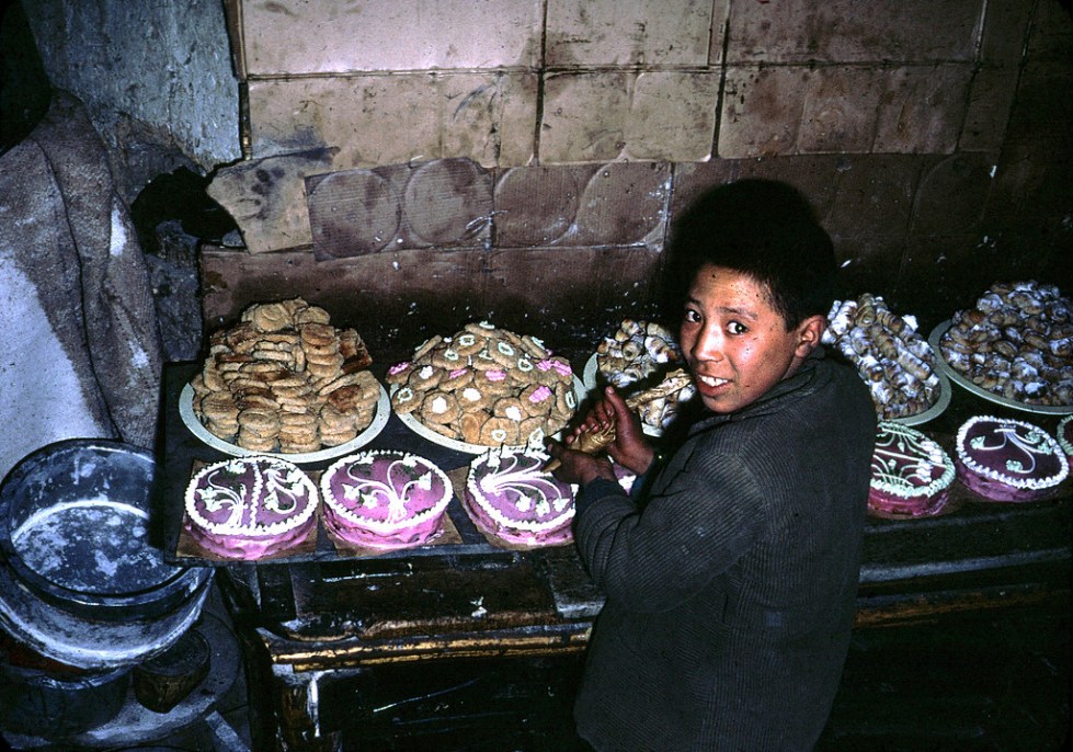 "An Afghan boy decorates cakes. "
